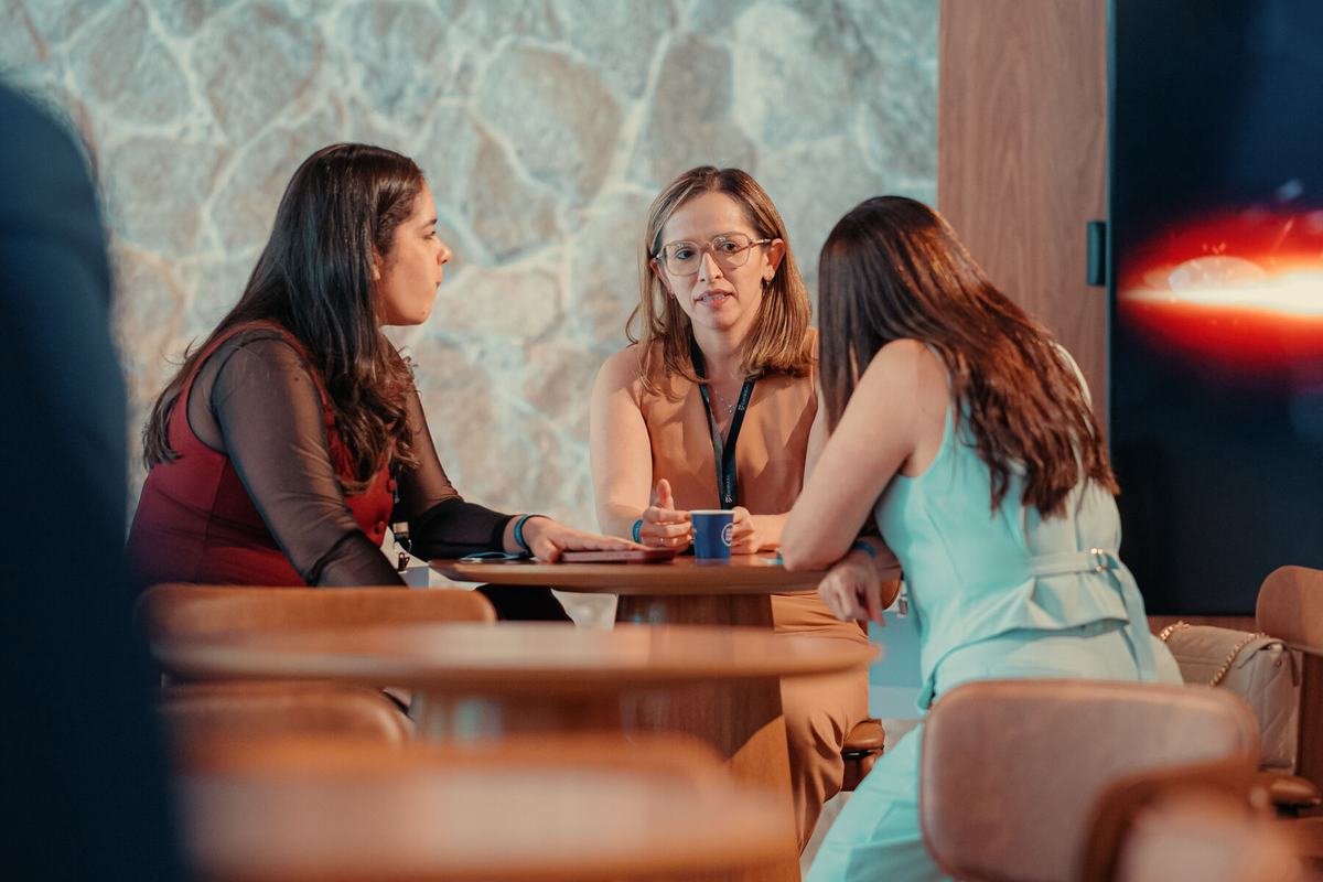 Conversa entre participantes em mesa de café
